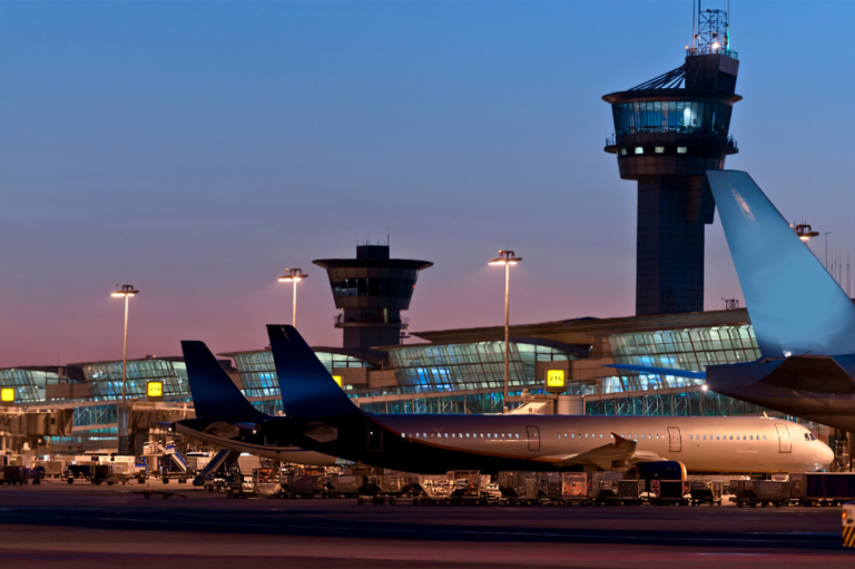 Aéroprt de nuit où l'on aperçoit plusieurs avion garé